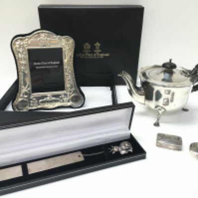 A collection of silver hallmarked items including a boxed Arthur Price of England photo frame, bookmark with cat pendant, pill boxes and a tea pot. Postage category B