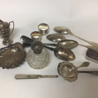 A box containing silver cutlery silver mounted scent bottle napkin rings and other silver and silver plate.