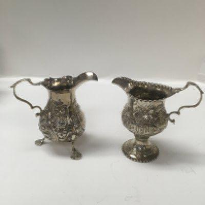 A George II silver cream jug and a George III 1771 silver jug.