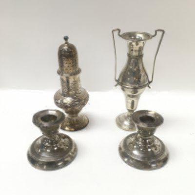 A small collection of silver items including a George III sterling silver caster by Thomas shepherd, an Edwardian silver vase and a pair of George V silver candle sticks.