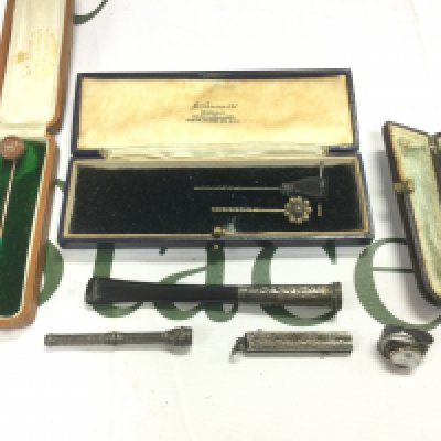 A collection of stick pins and silver items. Shipping category A.