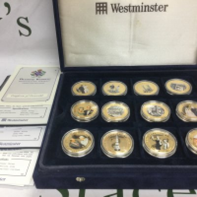 A cased collection of twenty four 2007 diamond wedding gold plated coins. Shipping category B.