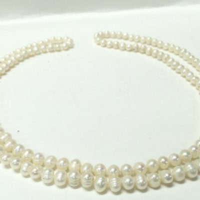 A 46 inch long white pearl necklace, postage category A