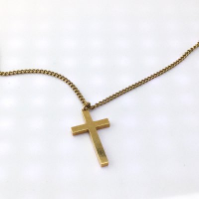 An 18ct cross on chain. Total weight 16.84g Postage A