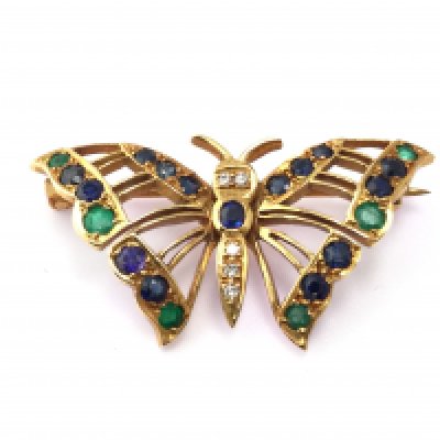 An 18ct gold butterfly brooch set with diamonds sapphires and emeralds. 6.60g Postage A