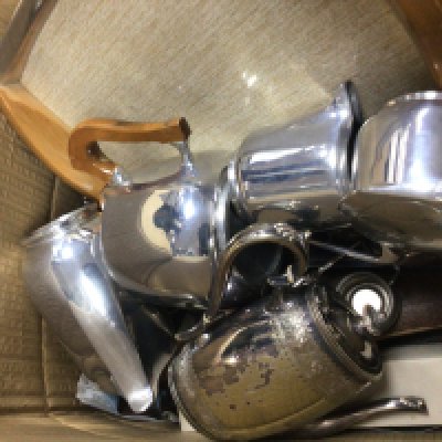 A box containing a mid 20th century design Picquot ware tea set and other silver plate.