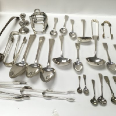 A collection of assorted silver items including spoons sugar tongs etc. Total weight 1.1kg Postage B