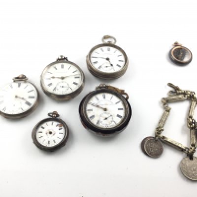 A collection of silver pocket watches and one other all in various condition. Also including a chain with silver coins on. Postage B