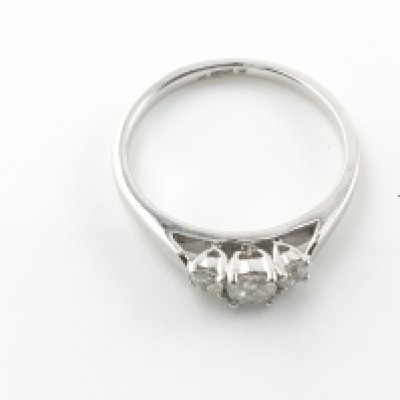 A platinum and 0.31ct diamond trilogy ring. Size M and 3.43g Postage A