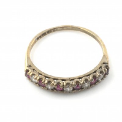 A 9ct gold ruby and diamond band ring. Size L and 1.35g Postage A