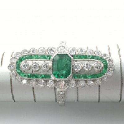 Platinum elongated ring set with emeralds and diamonds. Emeralds approx 0.73ct and 0.58ct diamonds with cert. Size J Postage A