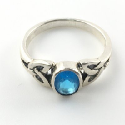 Silver Celtic style ring set with an oval light blue cubic zirconia. Size L. Postage A