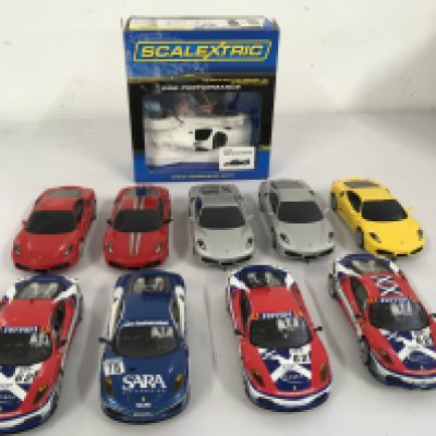 A collection of 10 Scalextric Hornby racing slot cars including a boxed self assembly Lola Aston Martin. No reserve
