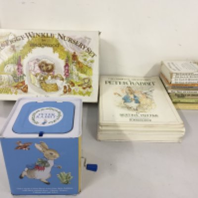 A collection of Peter Rabbit books together with jack in the box and a Mrs Tiggy Winkle breakfast set. No reserve.