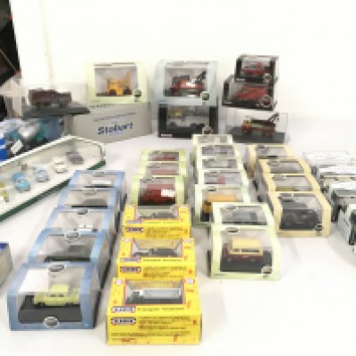 A collection of diecast model vehicles primarily by Oxford and mounted in display boxes. No reserve