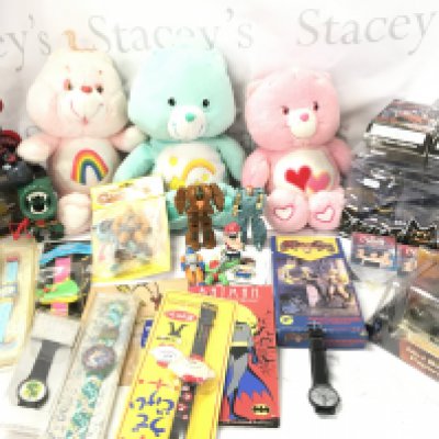 A Collection of Care Bears. Batman. Rock lords. Watches. Charmed Trading Cards Etc.