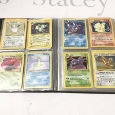 A Binder Containing A Small Collection Of Vintage Pokemon Cards.