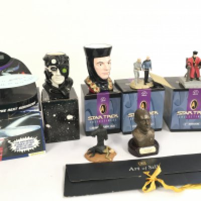 A collection of Star Trek pieces including a silk tie..an alarm clock..2 mugs..3 Minatures plus a Picard bust. No reserve