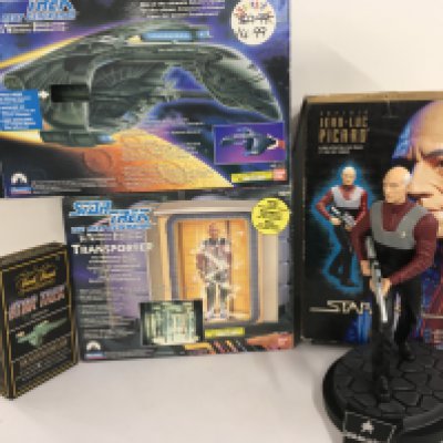 A collection of Star Trek boxed items including a Romulan Warbird.. Transporter toys plus a trivial pursuit. A boxed 12 inch cold cast figurine of Jean luc Picard. No 0001 of 5000 limited edition. No reserve