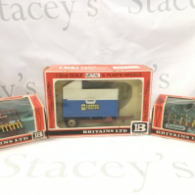 A Boxed Britains Buck Rake #9542. A Cultivator #9536 And A High Sided Tipper Cart #9566.