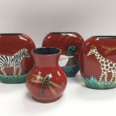 Four Sarah Ewin hand painted vases decorated with various animals on a red ground. Shipping category D.