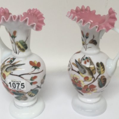A pair of opaque enamel decorated late Victorian art glass jugs decorated with birds. NO RESERVE