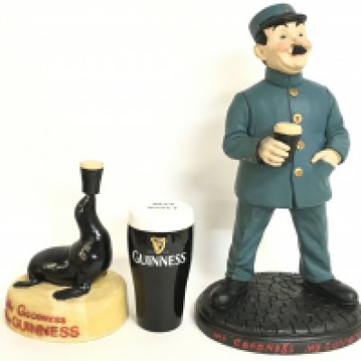 Three Guinness advertising items including a seal figure, Zoo Keeper and a money box (15 to 40cm tall). This lot cannot be posted