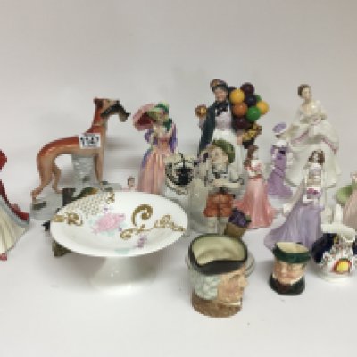 A collection of Royal Doulton lady figures Caricature jugs and other ceramics.