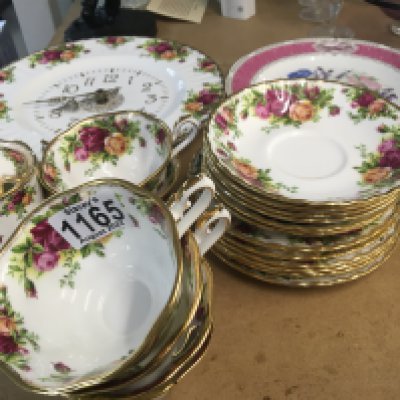 A Royal Albert Old English Country Rose porcelain tea set six place setting cups sauces side plates sugar bowl and a matching wall clock and Royal Horticulture Society plate. No obvious damage.
