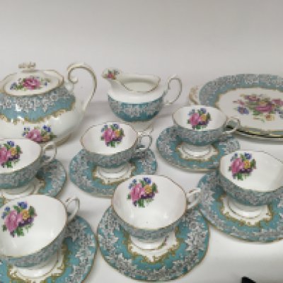 A Royal Albert Enchantment pattern tea set decorated with sprays of flowers six place setting no damage a d first quality.