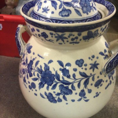 A large blue and white twin handle blue and white jar and cover decorated with flowers and foliage.