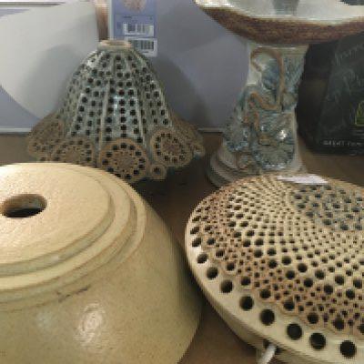 A collection of Bernard Rooke pottery including candle stick and two shades and base .