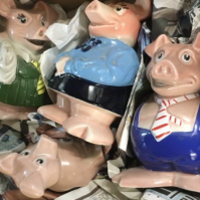 A collection of four Wade NatWest pigs .