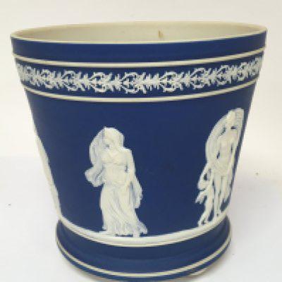 A late Victorian Jasper ware jardiniere decorated with classical figures on a blue ground with small bun feet no obvious damage height 19cm
