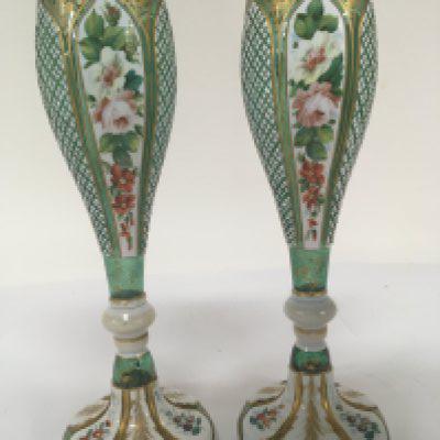 A pair of quality 19th century green overlay vases with shaped rims and applied gilt the alternating opaque glass panels hand decorated with enamel flowers and foliage. Height 25cm no obvious damage