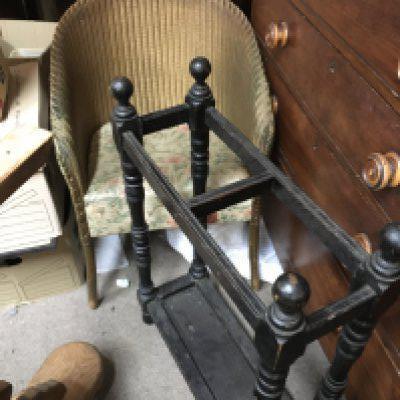 A wicker chair with floral patterned upholstery and a dark oak umbrella stand. NO RESERVE