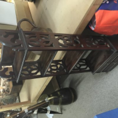 A mahogany etager with carved wooden sides, three shelves and two small drawers at the bottom. 112cm tall