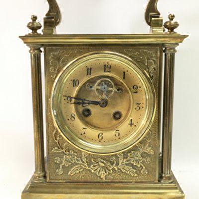 A brass mid 19th century French mantle clock with floral decoration . Dimensions 12x20x29cm. Cannot be posted