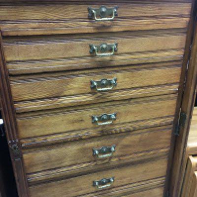 A oak wellington chest fitted with seven drawers on a plinth base . . 68x38 height heigh 120 cm .