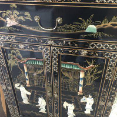 A Chinese black lacquer cabinet decorated with birds flowers and raised figures having a single drawer and double doors under.60 x30 cm height 90 cm .