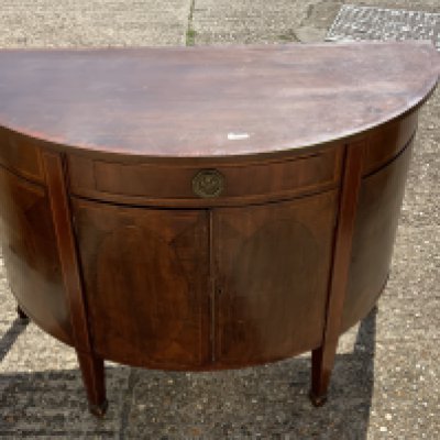 A 19th Century mahogany semi circular cabinet.