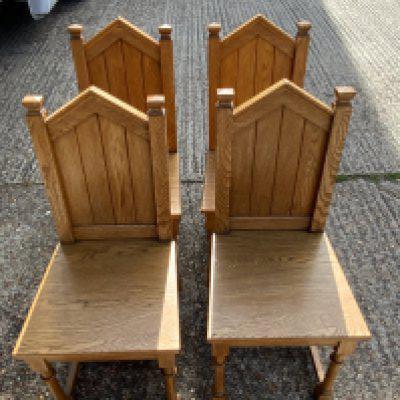 A set of 4 modern ecclesiastical steeple back design chairs.