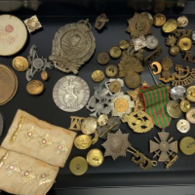 A collection of military buttons and badges including a Mine Clearance cap badge together with medallions etc. (B)