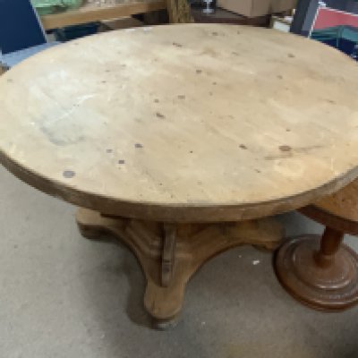 A large circular Victorian pine table.