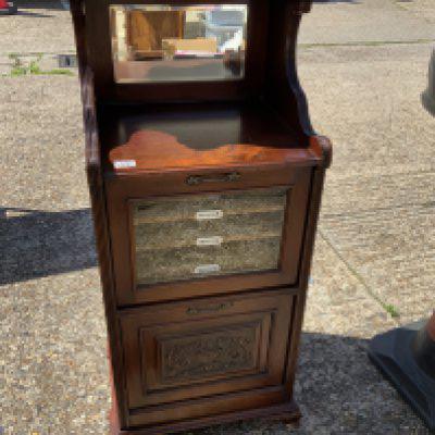 An Edwardian glazed front music cabinet.