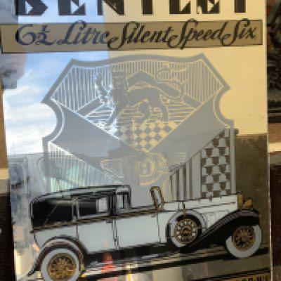 A modern unframed Bentley motors mirror