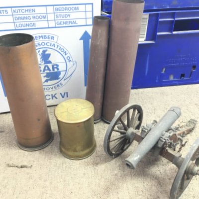 A collection of shell cases and a model canon. Postage category D