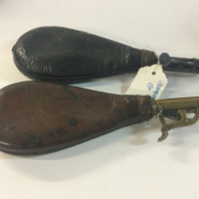 Two leather shot flasks with accessories.