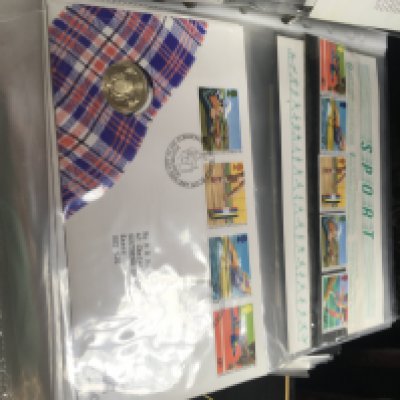 A collection of 17 albums containing first day covers and presentation packs .