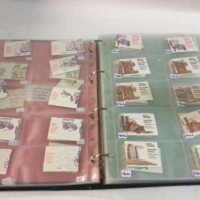 An album of folded stamp booklets.